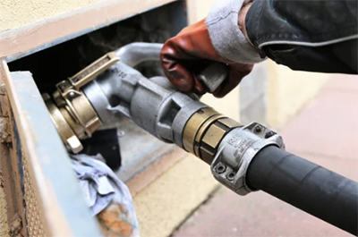 photo of a man making an oil delivery